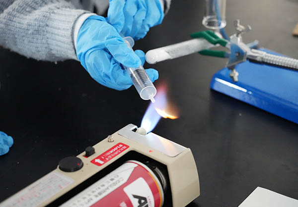 The color of the flame changes when ammonia gas is sprayed through it