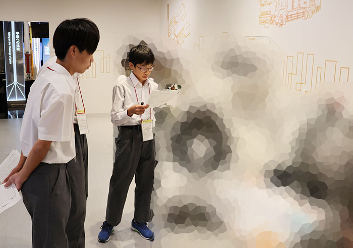 The three students each rehearse the explanations they are responsible for